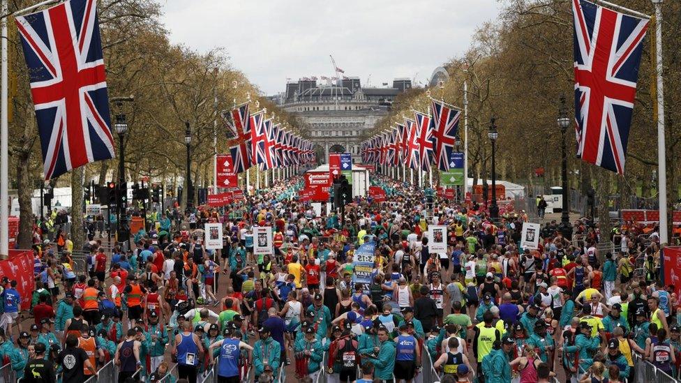 London Marathon runners collect their medals