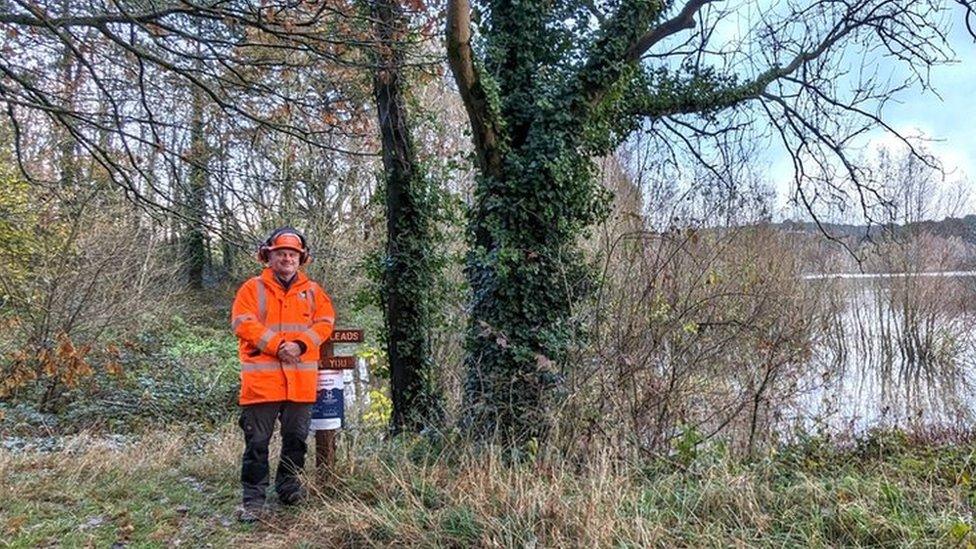 Simon Hughes next to trees and Blagdon Lake