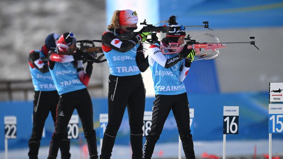 Athletes practice at the shooting range during the Biathlon Training Session at National Biathlon Centre