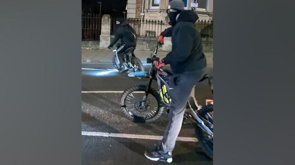 Two people on motorbikes