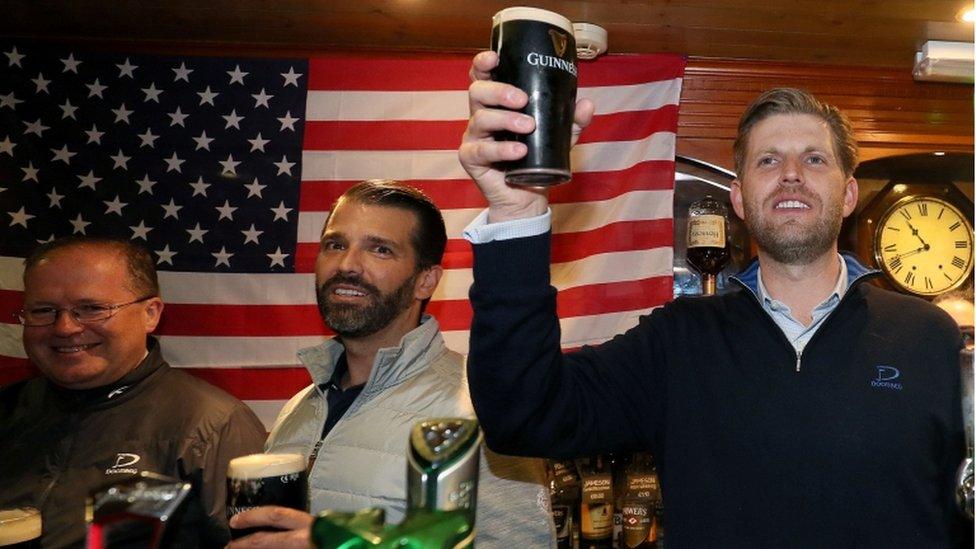 Donald Trump Jr. (centre), and Eric Trump (right), the sons of US President Donald Trump, behind the bar in Tubridy"s Bar in the village of Doonbeg, Co Clare, on the first day of US President Donald Trump"s visit to the Republic of Ireland