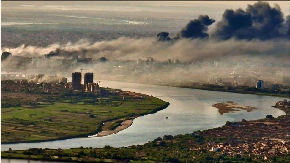 An aerial view of black smoke covering the sky above the capital Khartoum on 23 April