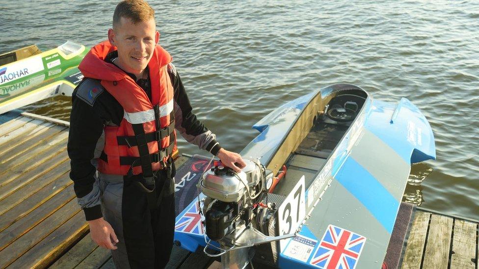 James Bowman standing by a boat