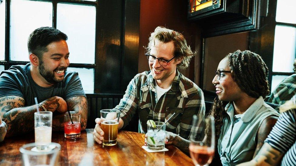 People drinking in a pub