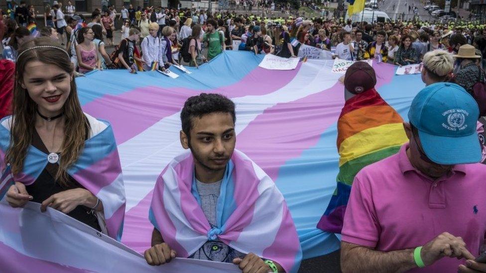 Participants hold a flag at Kiev Pride