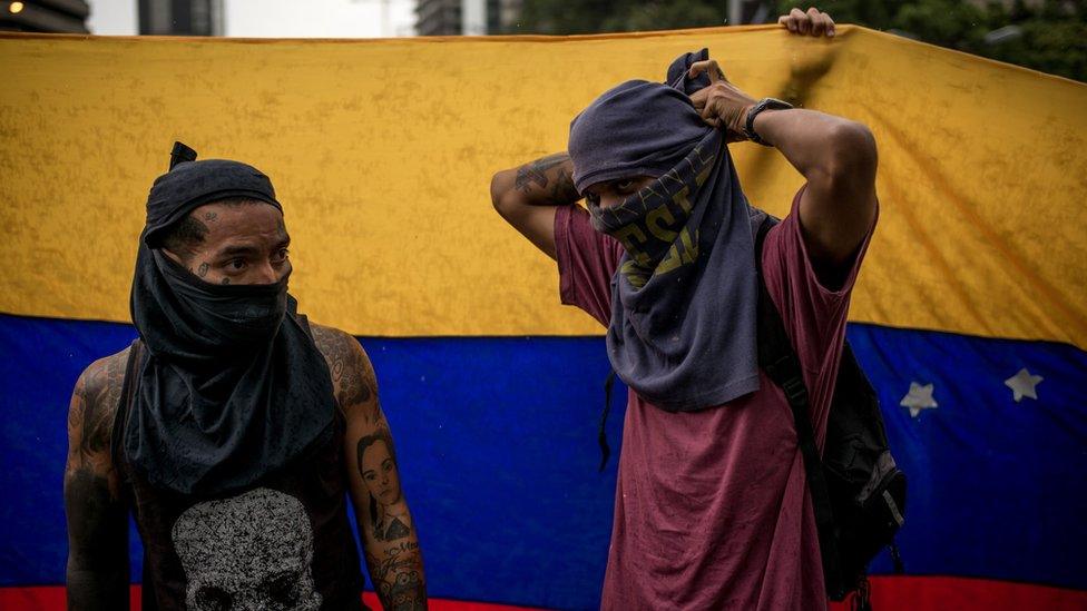 People wear masks made out of T-shirts