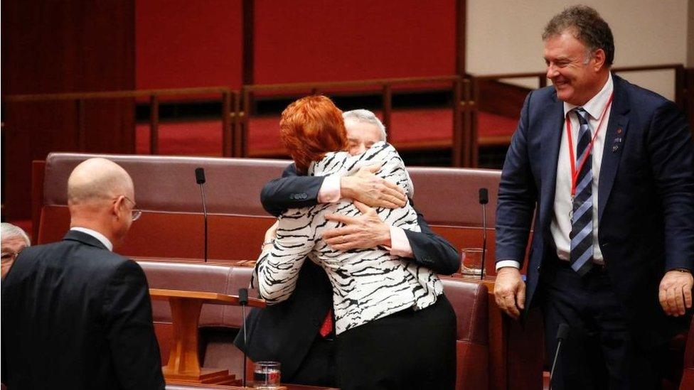 Senator Malcolm Roberts embraces One Nation leader Pauline Hanson