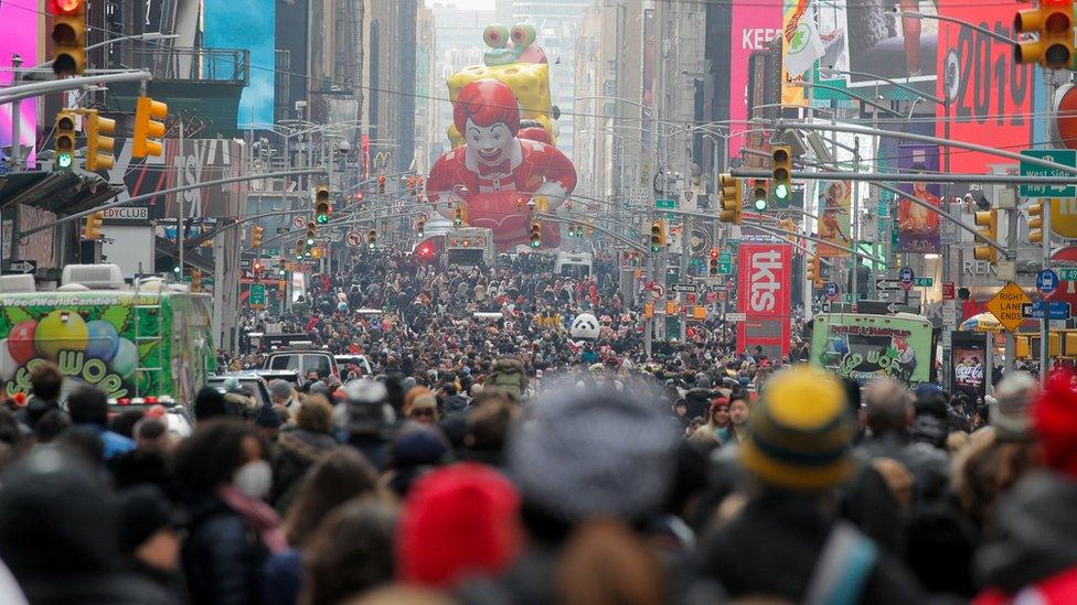 People attend the 95th Macy"s Thanksgiving Day Parade in Manhattan