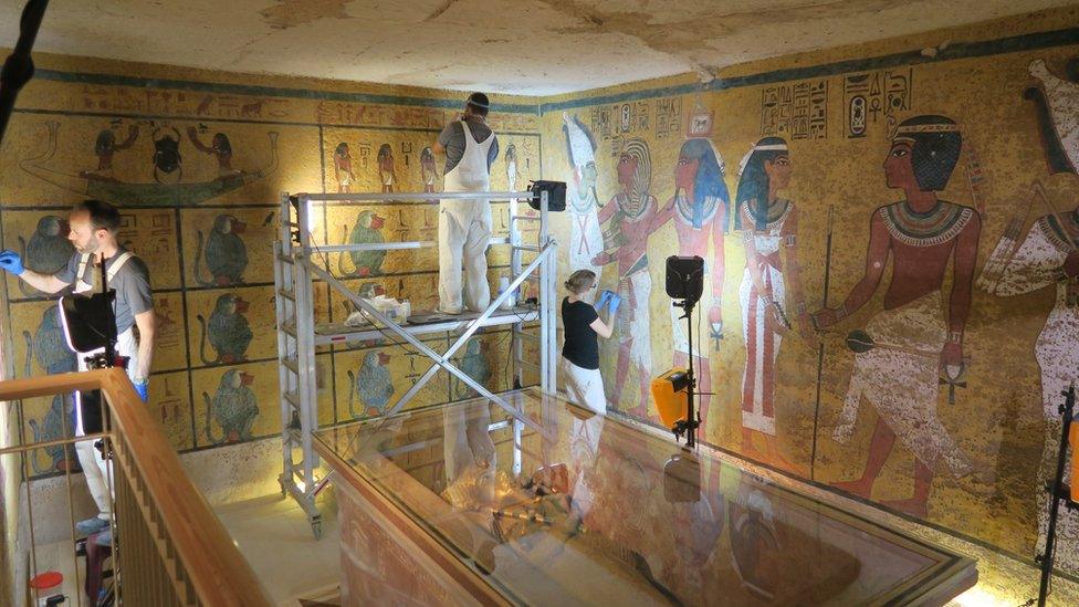 Conservationists work on large wall-paintings in Tutankhamun's tomb