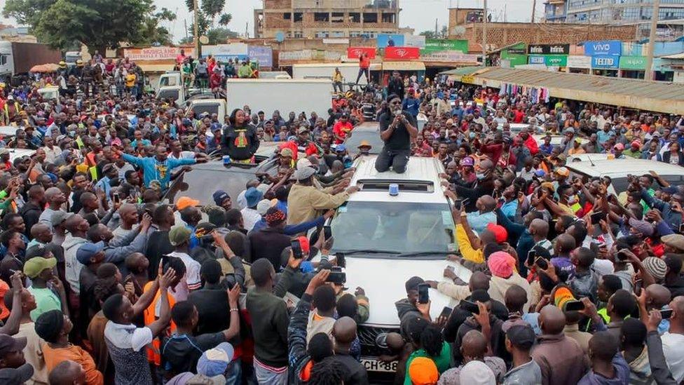 George Wajackoyah on top of a white campaign vehicle