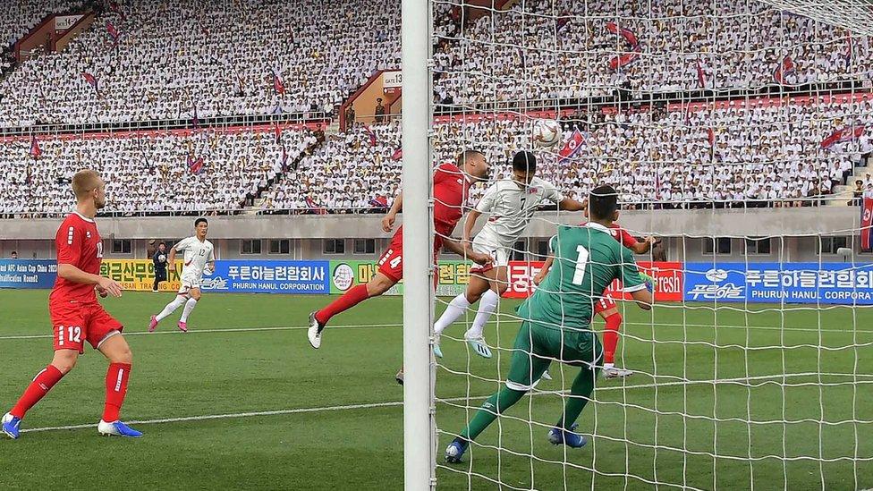 North Korea's Han Kwang-song fights for the ball with Lebanon's Nour Mansour at the Kim Il Sung Stadium, Pyongyang, in September 2019