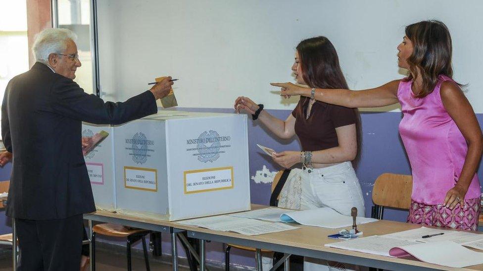 Italian President Sergio Mattarella (L) casts his ballot at a polling station during voting for the general election, in Palermo, Sicily