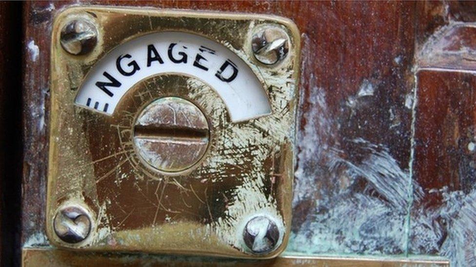 Engaged sign on public toilet door