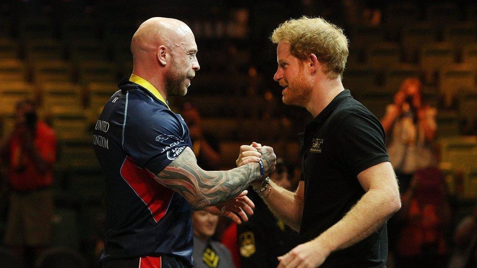 Michael Yule receives a handshake from Prince Harry of Wales after winning the gold medal in the Men's Lightweight Powerlifting finals during the Invictus Games Orlando 2016