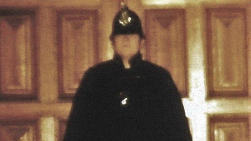 Chris Clark in police uniform stands outside the door at Sandringham