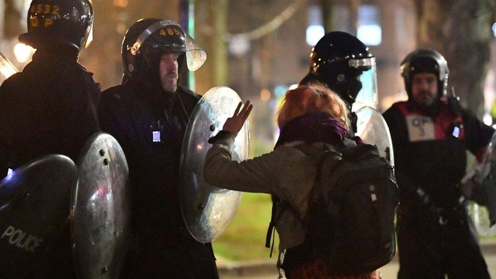 Protesters and police at the scene