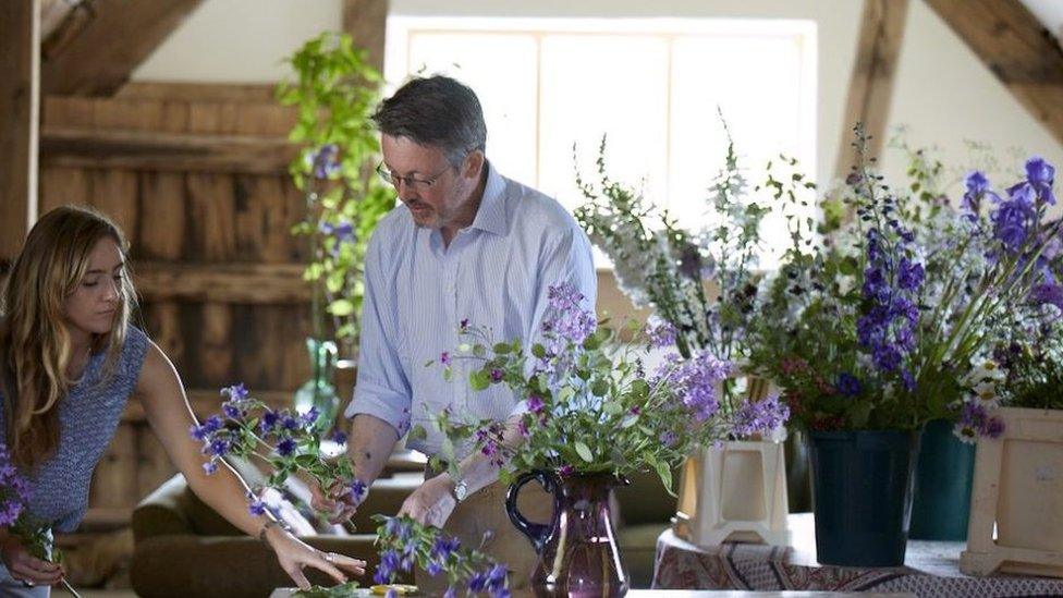 Shane Connolly arranging purple flowers for the Coronation