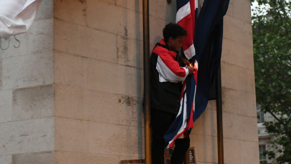 The person who climbed onto the Cenotaph during protests