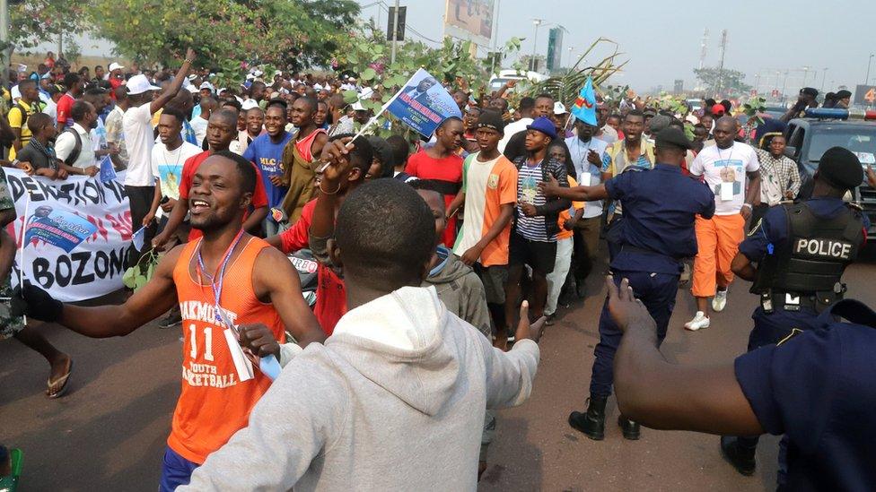 Supporters of Congolese opposition leader Jean-Pierre Bemba chant slogans outside the N"djili International Airport as he arrives in Kinshasa, Democratic Republic of Congo August 1, 2018.