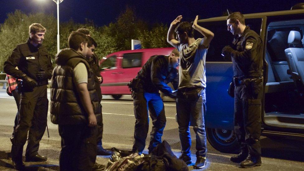 A policeman checks a Syrian migrant on 13 September 2015, in the southern German city of Freilassing at the border between Germany and Austria, after Berlin's shock decision to reintroduce such controls to halt a surge in refugee numbers