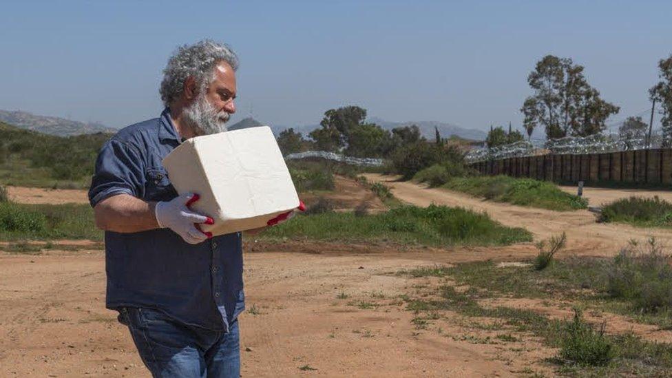 Cosimo Cavallaro carrying a cheese brick