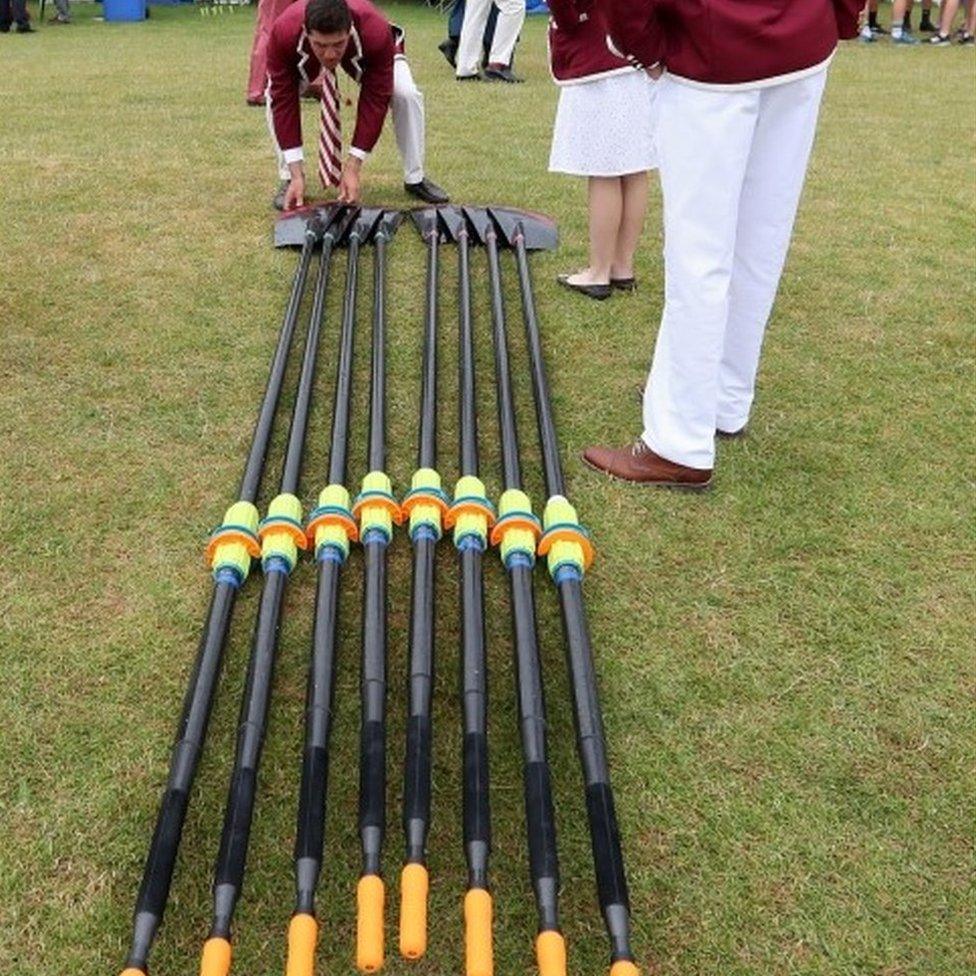 Crew from the Tabor Academy in Massachusetts, USA, adjust their oars outside the boat tent