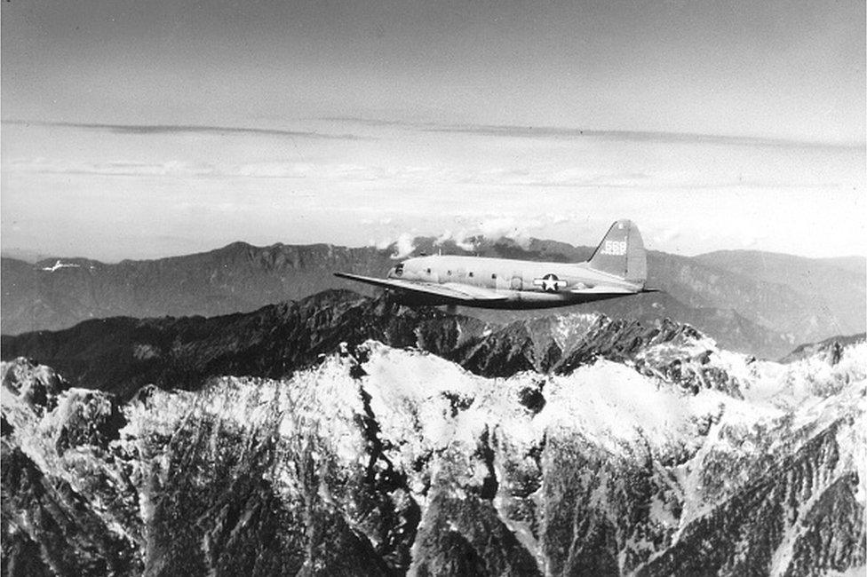 View of a US Army Air Transport Command cargo plane as it flies over the snow-capped, towering mountains of the Himalayas, along the borders of India, China, and Burma, January 1945, February 20, 1945.