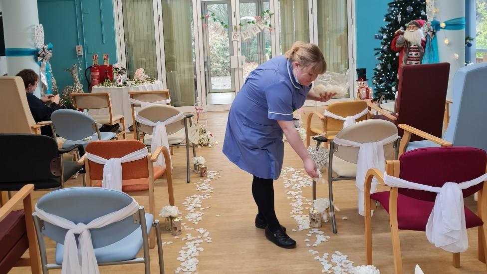 Nurse decorating the ceremony hall ahead of the wedding