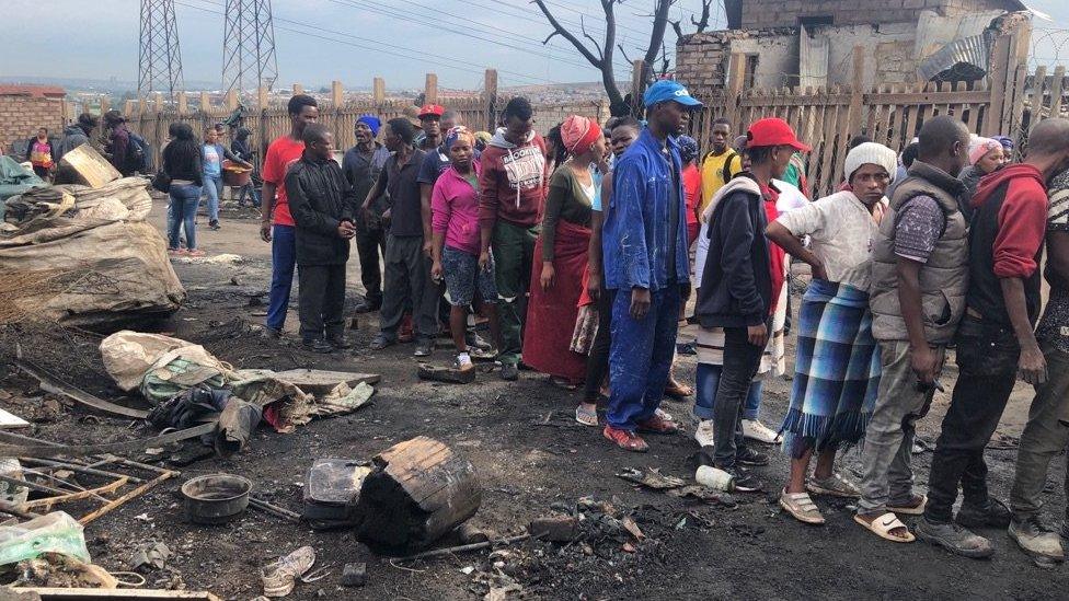 Residents pictured after the suspected arson attack