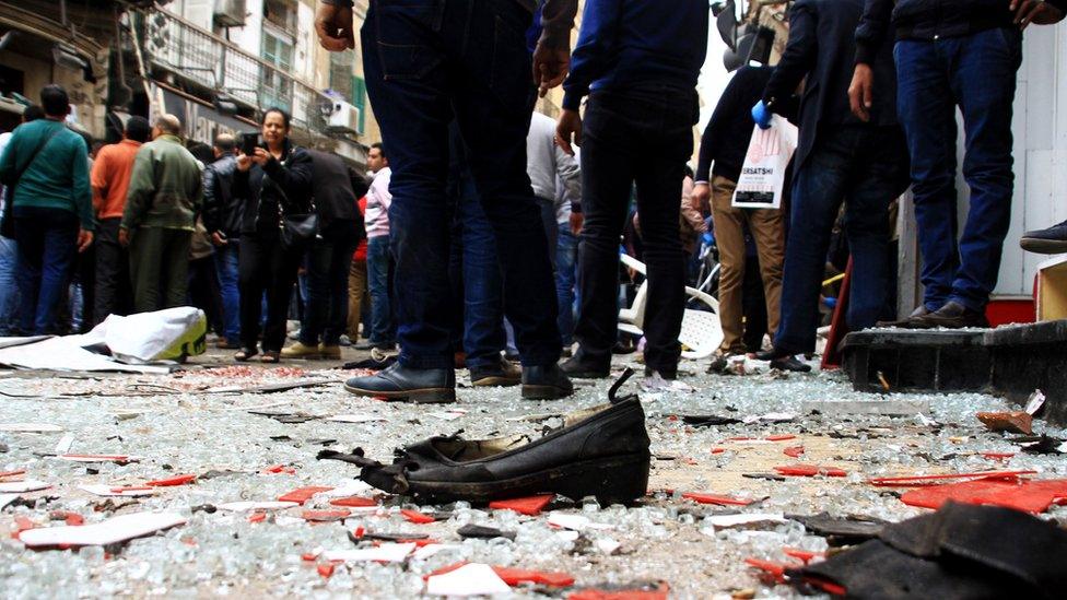 Security personnel investigate the scene of a bomb explosion outside the Saint Mark's Coptic Cathedral in Alexandria