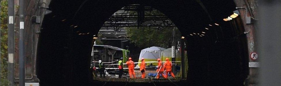 Emergency workers continue to work at the scene of a derailed tram in Croydon