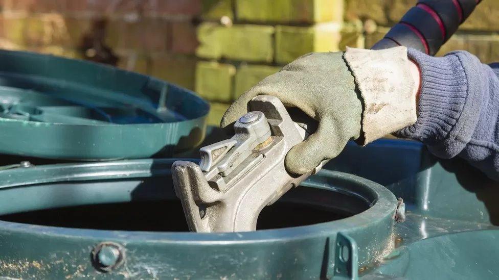 Man filling oil tank with domestic heating kerosene