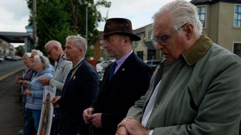 Anti-abortion protestors pray outside hospital