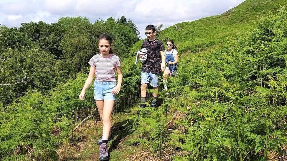 The Rushworth children walk through greenery