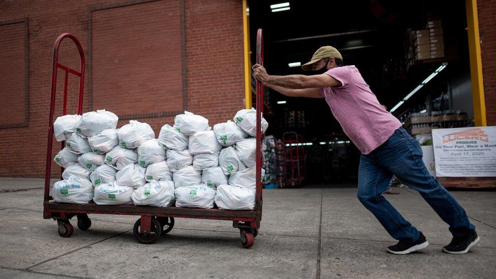 Felix Pinzon, an unemployed construction worker pushes a cart of food delivery donations on May 19, 2020 in the Bronx borough of New York City.