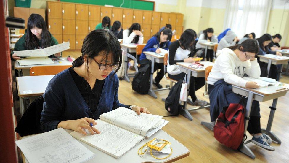 A classroom of students taking the CSAT exam