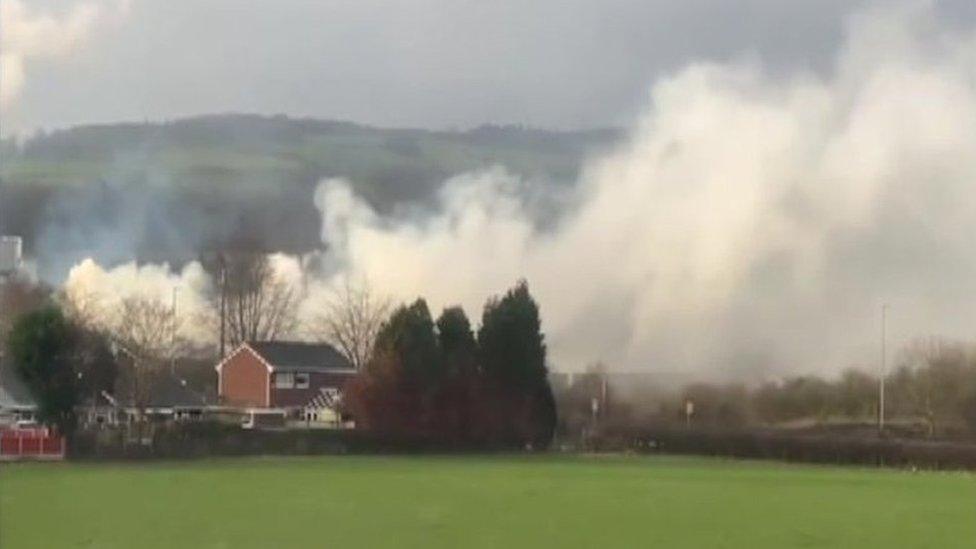 Smoke blowing over house