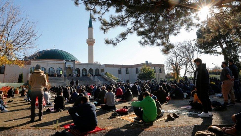 Muslims pray for victims of a gun attack during their Friday prayer, outside the mosque in Vienna, Austria November 6, 2020