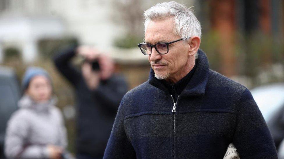 Gary Lineker walking outside his home with members of the press behind him