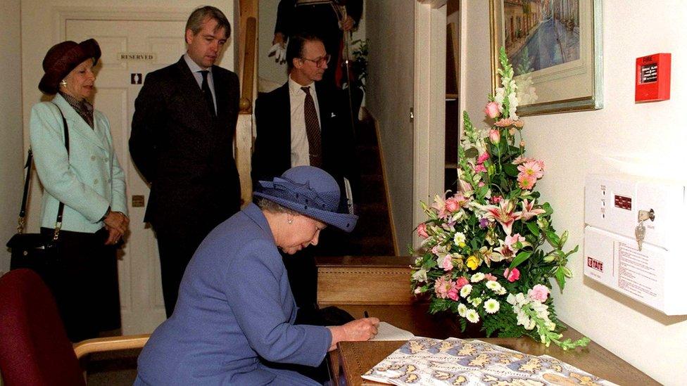 The Queen Visiting Poundbury In Dorset in 2008. Sir Robert Fellowes At Bottom Of Staircase And Wearing Glasses) (Photo by Tim Graham Photo Library via Getty Images)