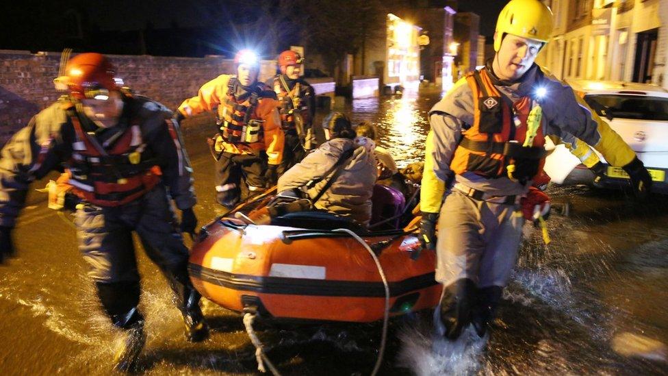 Woman being rescued in lifeboat