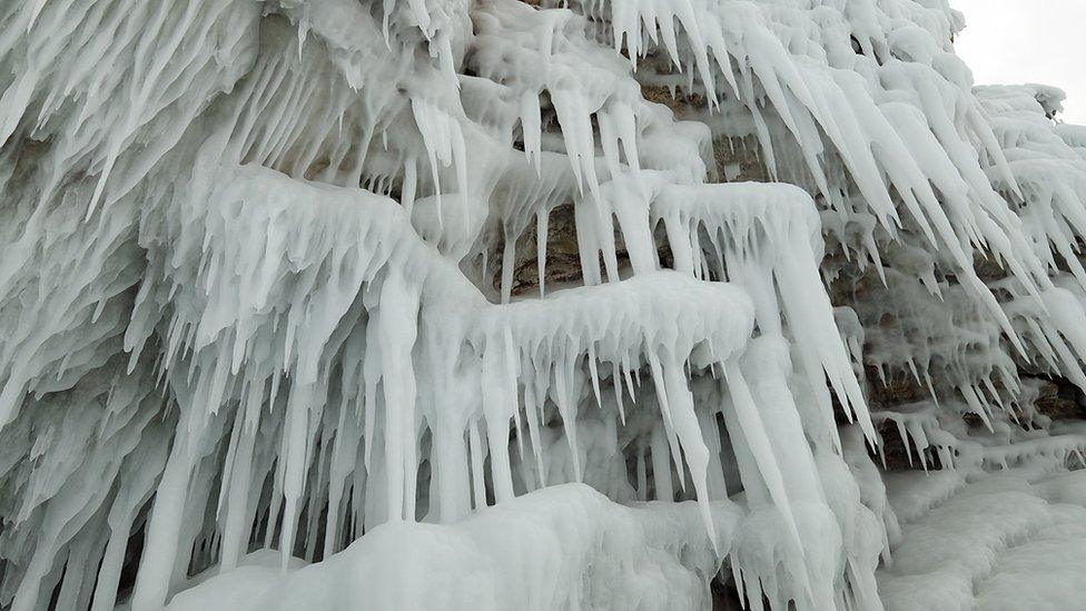 close up of ice sculptures hanging off a cliff