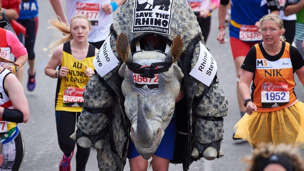 A runner 'Rhino Steve' in a Rhino fancy dress costume takes part in the 2016 London Marathon in central London on April 24, 2016