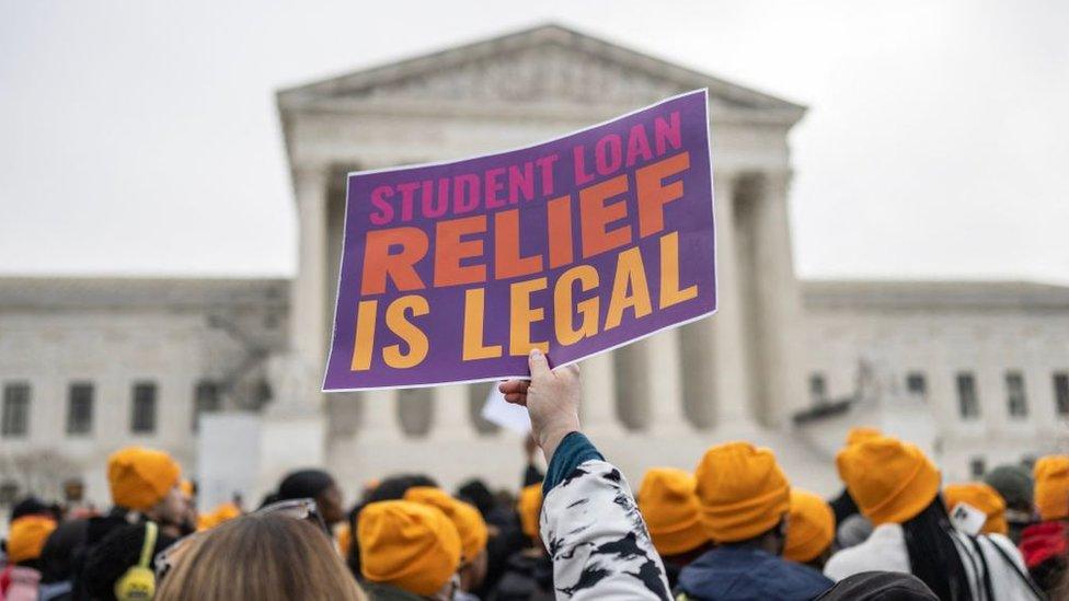 Activists and students protest in front of the Supreme Court during a rally for student debt cancellation