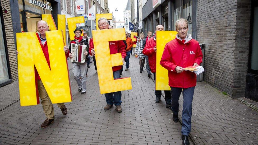 Dutch Socialist Party member Harry van Bommel hands out flyers for the No-campaign