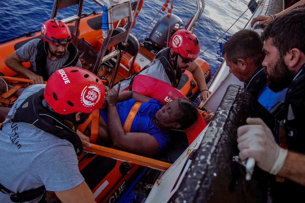 NBA Memphis player Marc Gasol and members of NGO Proactiva Open Arms rescue boat carry Josepha from Cameroon in central Mediterranean Sea