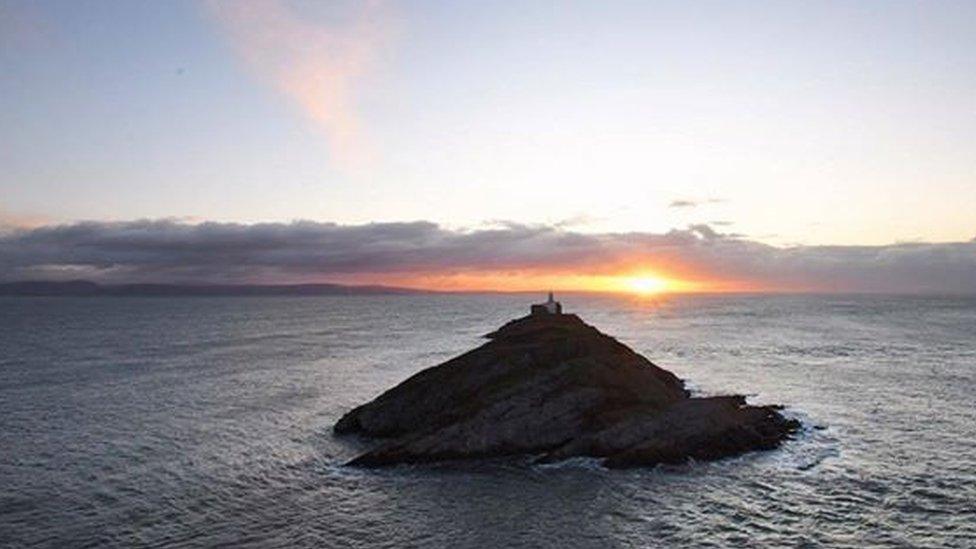 Mark de'Boer Lloyd took this picture of the sun rising behind Mumbles lighthouse.