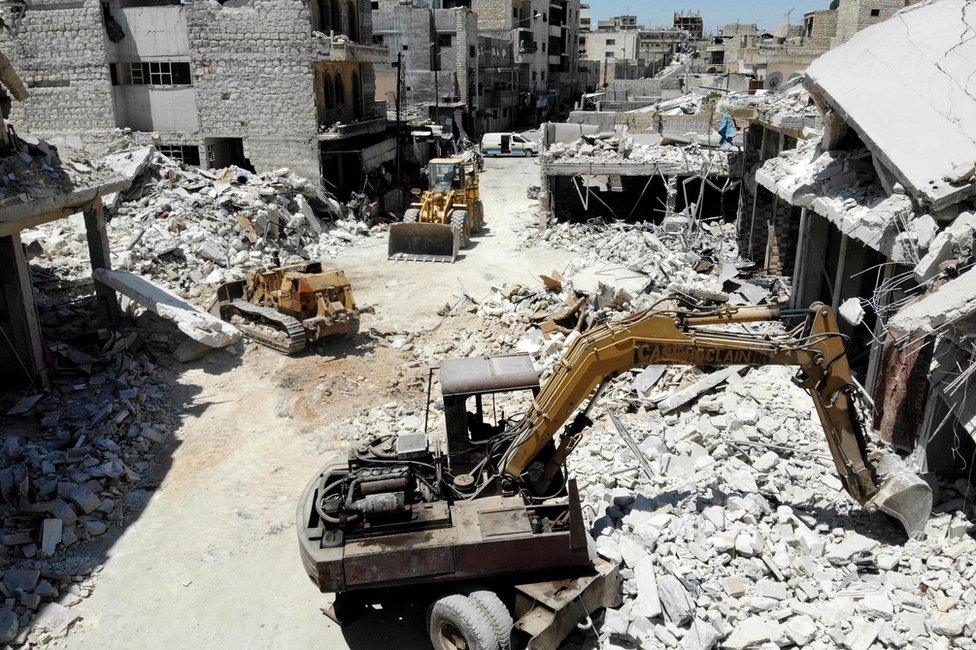 Excavators and bulldozers are used to search for victims after an air strike on a market place in the opposition-held town of Maarat al-Numan, Syria (22 July 2019)