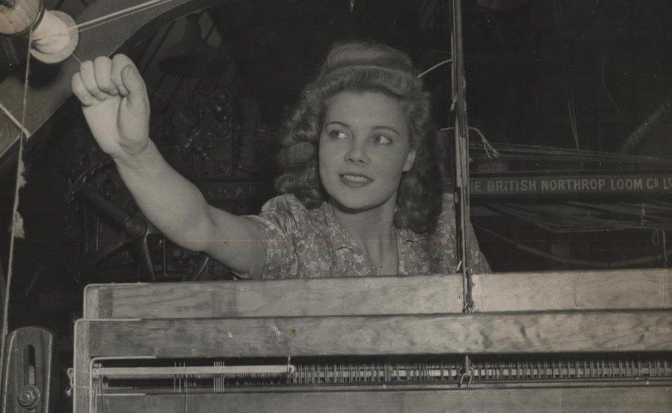 Woman working at a weaving machine