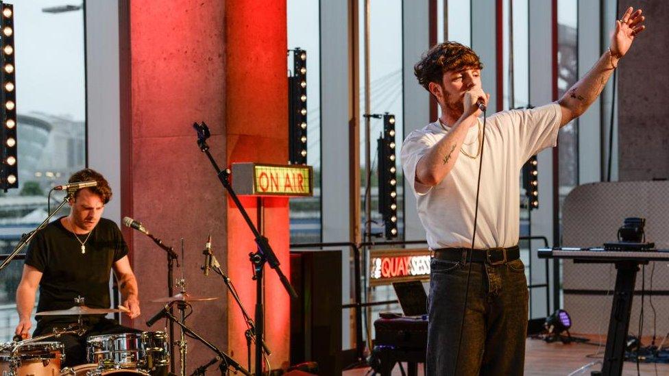 Tom Grennan performing with Adam Gammage